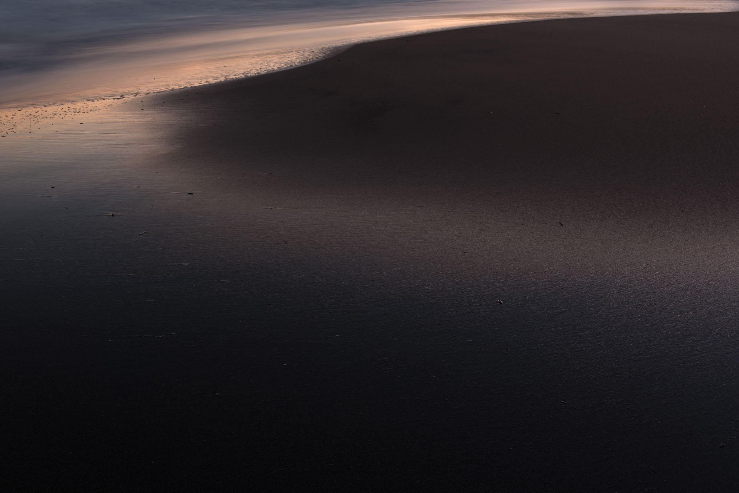 Warm light along the edge of a dark sandbar