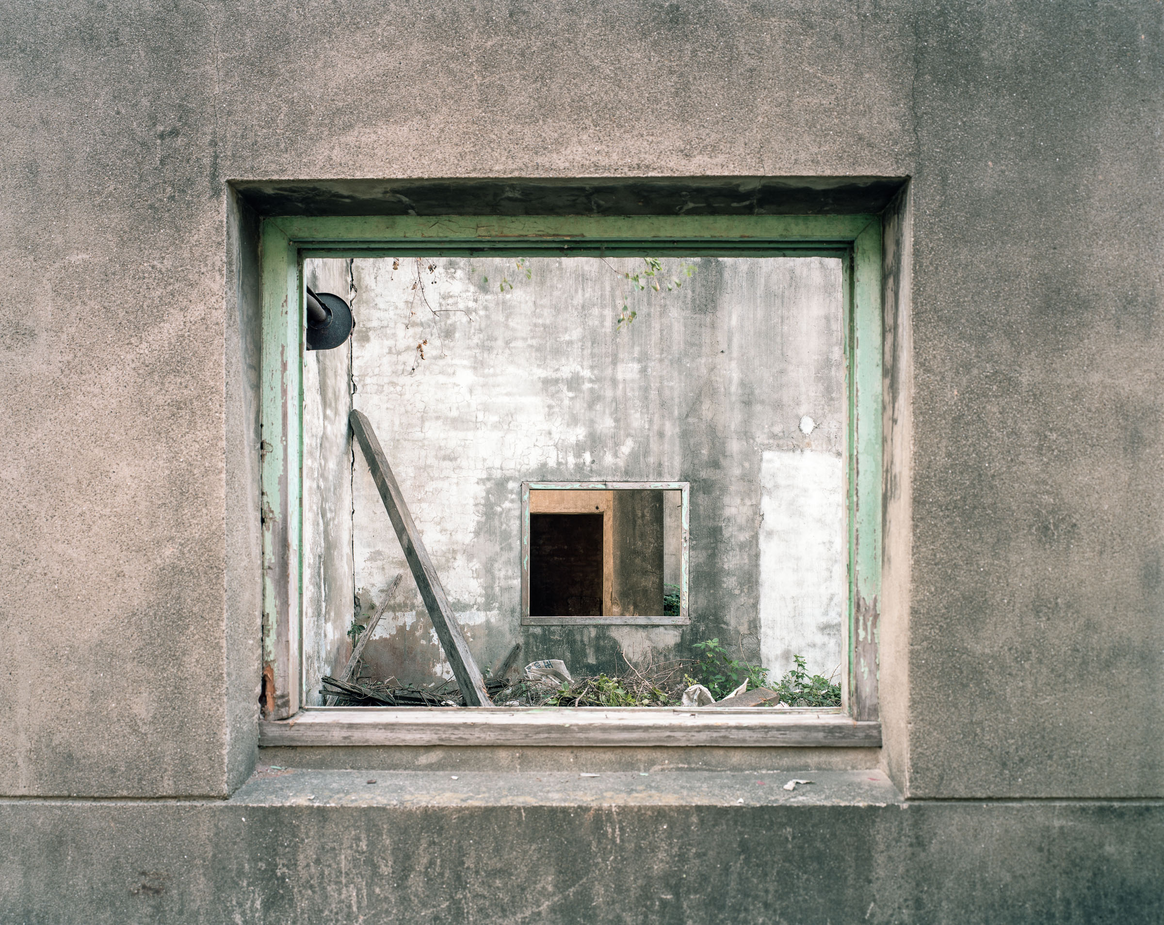 Empty window frames aligned through weathered concrete walls